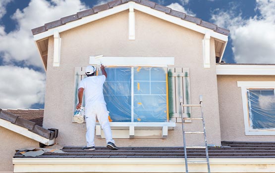 painter painting on house